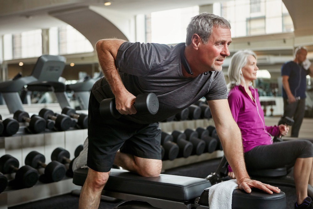 Fitness, weights and senior man in gym for workout, training and cardio exercise for healthy body. Retirement, sports and person with dumbbell equipment for wellness, muscle strength and mobility.